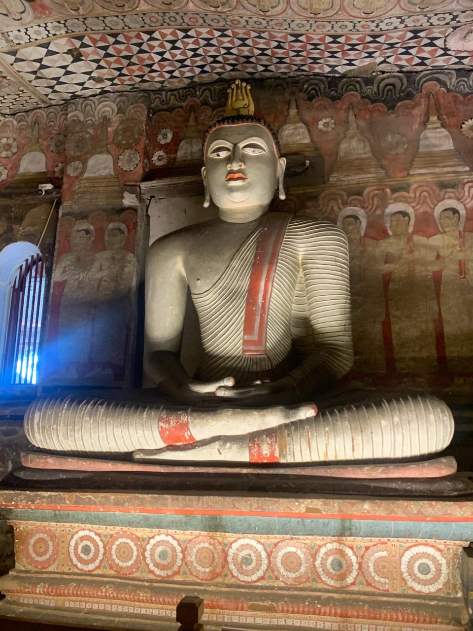 two statues of buddhas sitting in a room