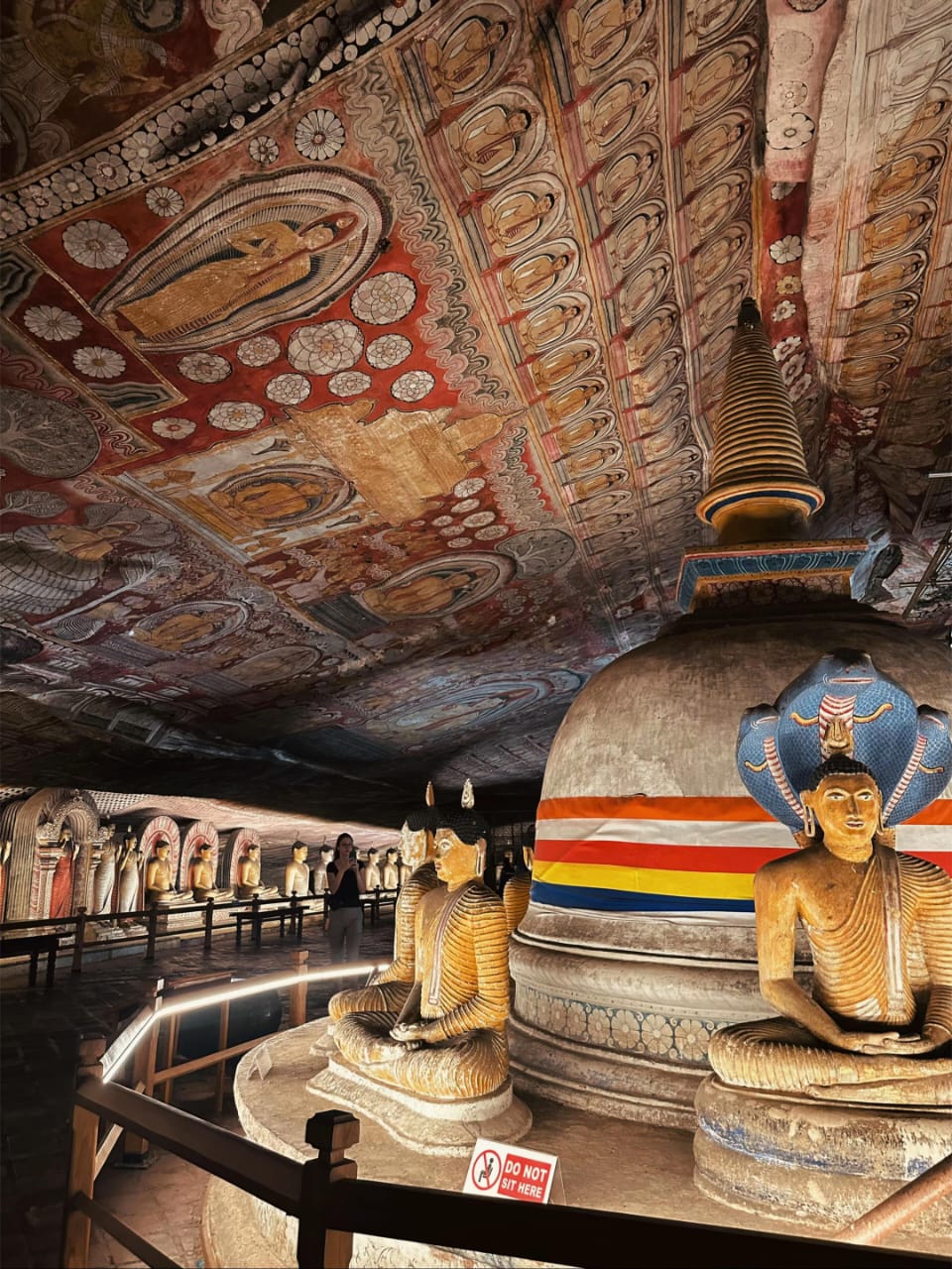 two statues of buddhas sitting in a room